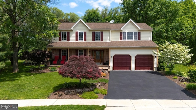 4361 Sutton Cir, Reading, PA 19606 - view of front facade featuring asphalt driveway, an attached garage, a front yard, and covered porch