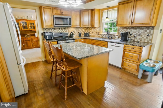 4361 Sutton Cir, Reading, PA 19606 - kitchen featuring appliances with stainless steel finishes, a sink, dark wood-style flooring, a kitchen island, and dark stone countertops