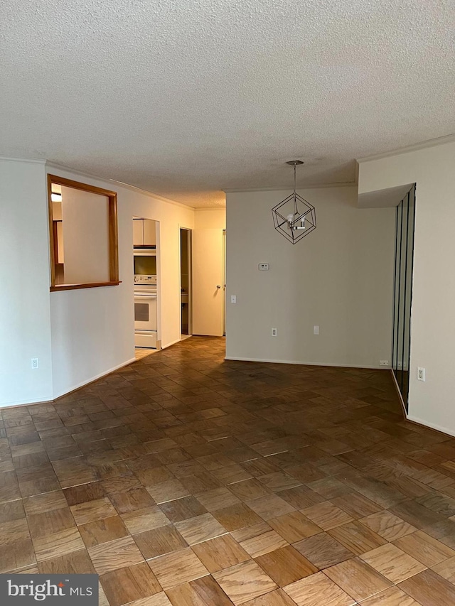 unfurnished room with a textured ceiling