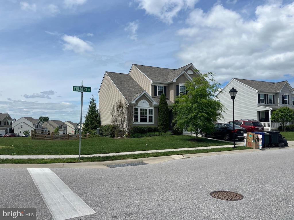 view of front facade featuring a front lawn and a residential view