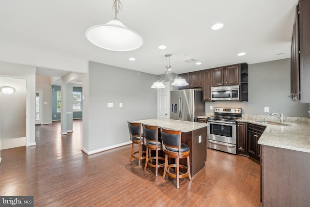 199 Colbert St, Taneytown, MD 21787 - kitchen with stainless steel appliances, a sink, open shelves, dark brown cabinets, and a center island