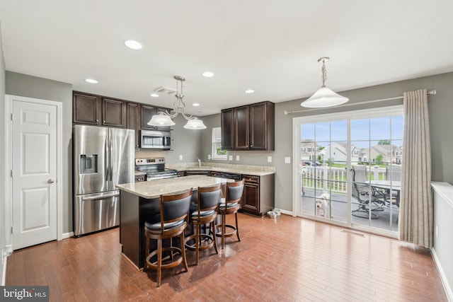 199 Colbert St, Taneytown, MD 21787 - kitchen with stainless steel appliances, dark brown cabinetry, hardwood / wood-style floors, a kitchen island, and a sink