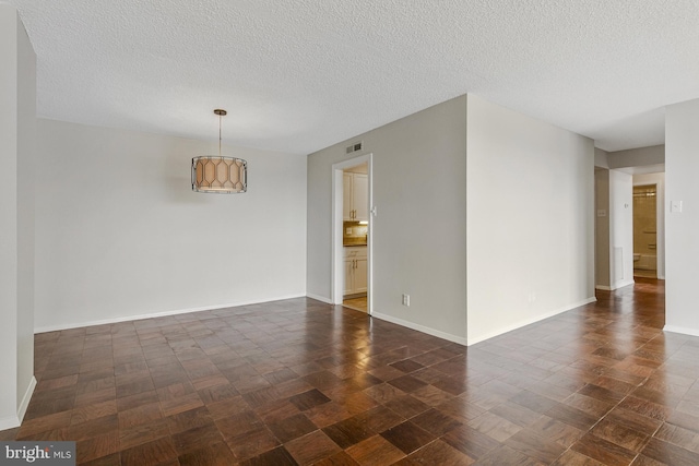 3800 Fairfax Dr Unit 1011, Arlington, VA 22203 - spare room with a textured ceiling and baseboards