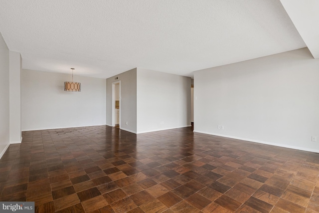3800 Fairfax Dr Unit 1011, Arlington, VA 22203 - unfurnished living room featuring a textured ceiling and baseboards