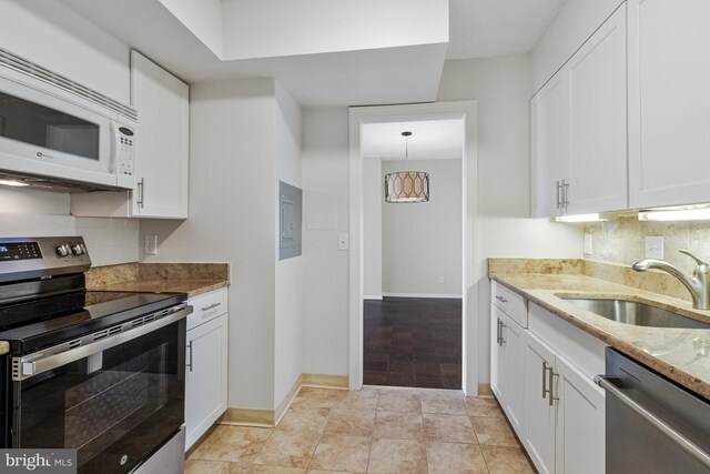 3800 Fairfax Dr Unit 1011, Arlington, VA 22203 - kitchen featuring stainless steel appliances, a sink, tasteful backsplash, light stone countertops, and white cabinetry