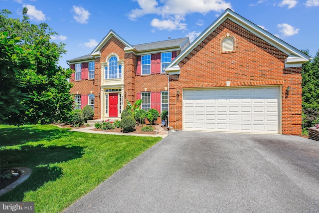 7229 Antares Dr, Gaithersburg, MD 20879 - colonial inspired home featuring asphalt driveway, brick siding, a front yard, and a garage