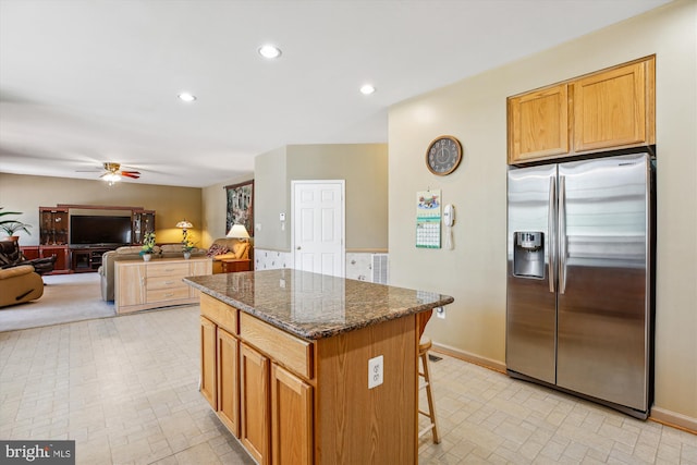 7229 Antares Dr, Gaithersburg, MD 20879 - kitchen with stainless steel fridge, a center island, a ceiling fan, open floor plan, and dark stone counters