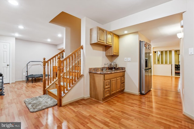 7229 Antares Dr, Gaithersburg, MD 20879 - kitchen featuring stainless steel fridge with ice dispenser, light wood-type flooring, a sink, recessed lighting, and dark stone counters