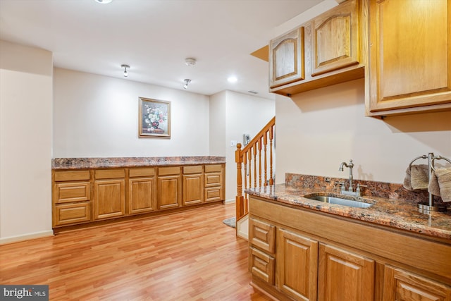 7229 Antares Dr, Gaithersburg, MD 20879 - kitchen featuring a sink, light wood-style floors, stone counters, recessed lighting, and baseboards
