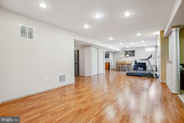 7229 Antares Dr, Gaithersburg, MD 20879 - living area with decorative columns, light wood-style flooring, recessed lighting, and baseboards