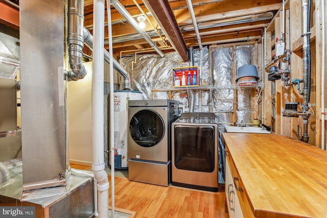 7229 Antares Dr, Gaithersburg, MD 20879 - laundry area featuring separate washer and dryer, water heater, and wood finished floors