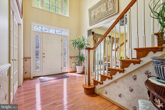 7229 Antares Dr, Gaithersburg, MD 20879 - foyer with stairs, a high ceiling, hardwood / wood-style flooring, and baseboards
