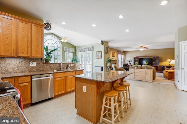 7229 Antares Dr, Gaithersburg, MD 20879 - kitchen with dishwasher, ceiling fan, a sink, a kitchen island, and lofted ceiling