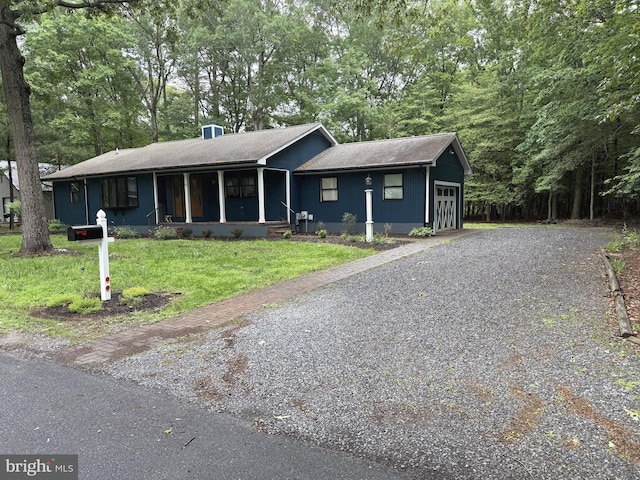 5 Kent Ave, Ocean View, DE 19970 - view of front of property featuring a front lawn, a garage, a porch, driveway, and a shingled roof