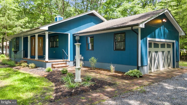 5 Kent Ave, Ocean View, DE 19970 - view of front facade featuring covered porch, roof with shingles, and a garage