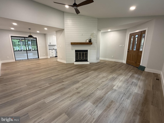 5 Kent Ave, Ocean View, DE 19970 - unfurnished living room featuring vaulted ceiling, ceiling fan, a fireplace, recessed lighting, and light wood finished floors