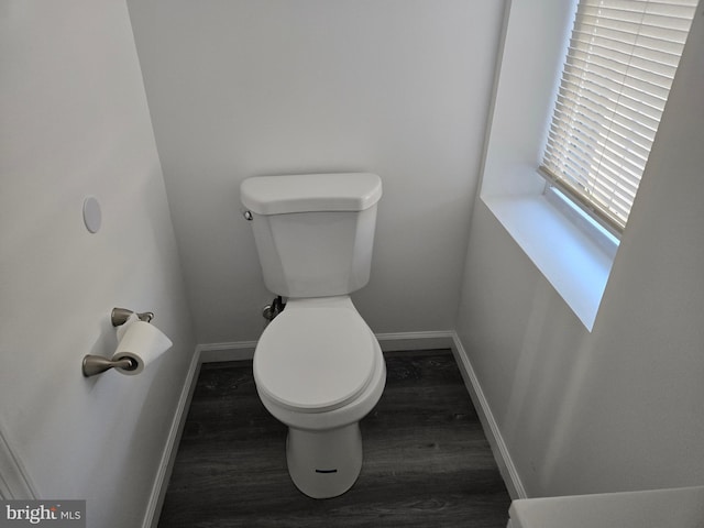 bathroom featuring wood finished floors, toilet, and baseboards