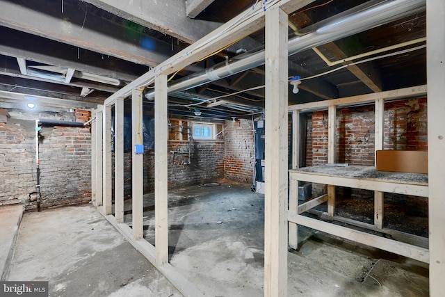 below grade area featuring brick wall