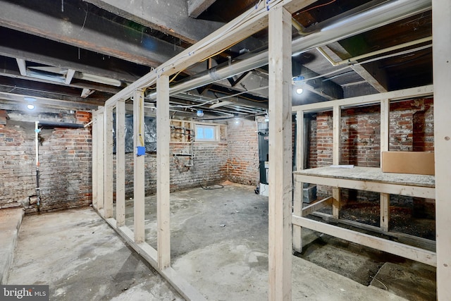 basement with brick wall
