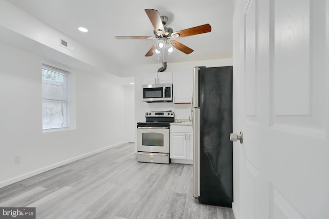 kitchen with appliances with stainless steel finishes, white cabinetry, light wood finished floors, ceiling fan, and light countertops