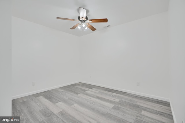 unfurnished room featuring light wood finished floors, a ceiling fan, and baseboards