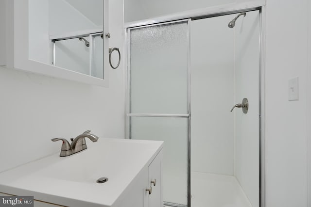 full bathroom with a stall shower and vanity