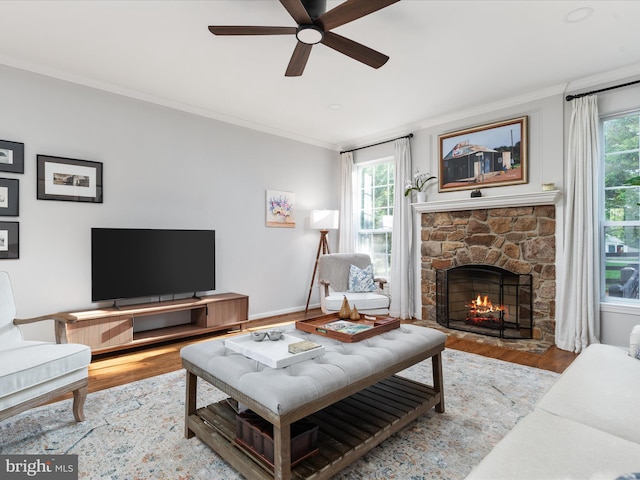 35513 Sourwood Pl, Round Hill, VA 20141 - living room with a ceiling fan, wood finished floors, plenty of natural light, crown molding, and a fireplace