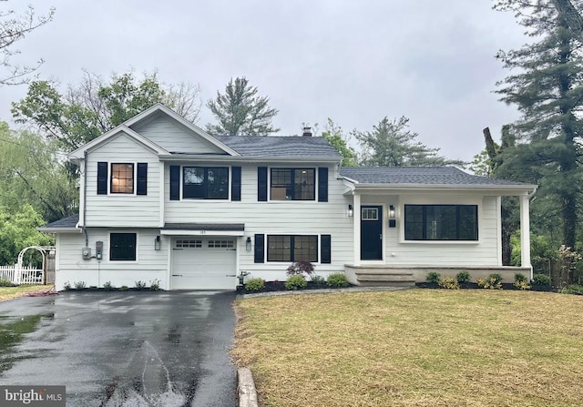 split level home featuring driveway and a garage