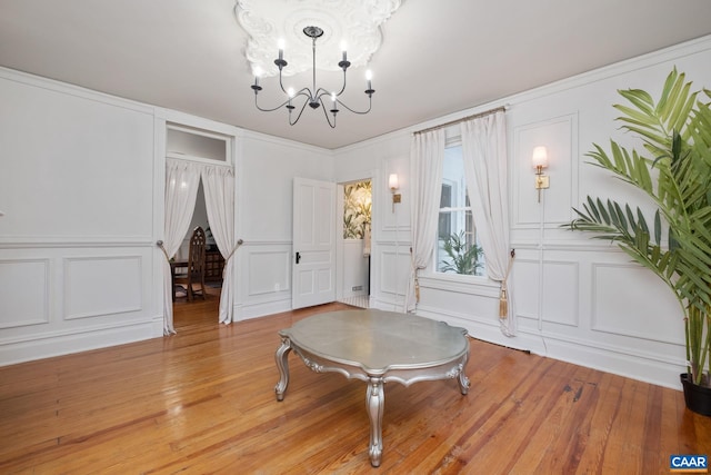 2010 White Bridge Rd, Waynesboro, VA 22980 - dining space featuring a decorative wall, a chandelier, light wood finished floors, and crown molding