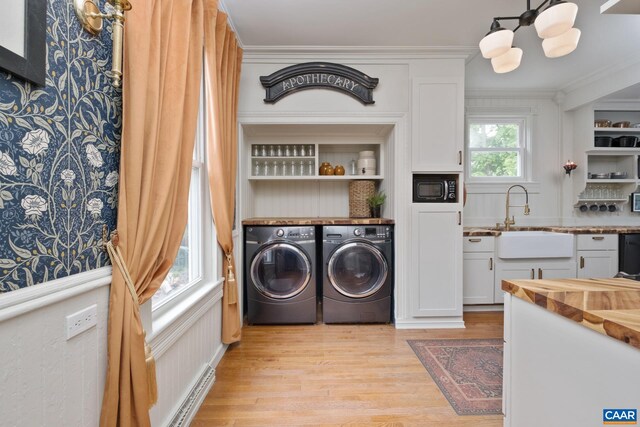 2010 White Bridge Rd, Waynesboro, VA 22980 - laundry room featuring washing machine and dryer, light wood-style flooring, a chandelier, and crown molding