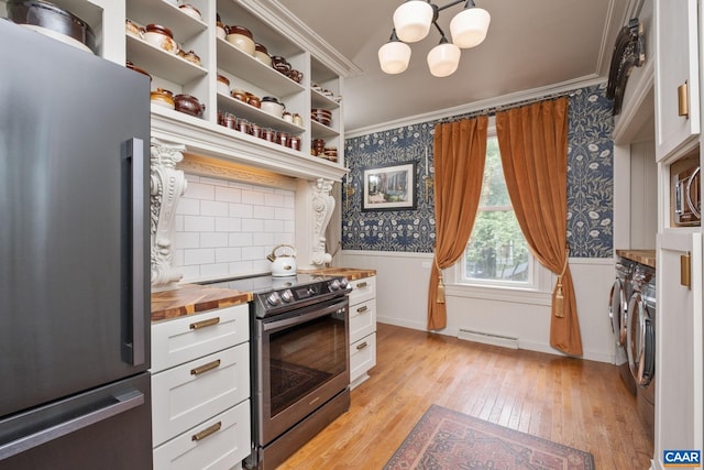 2010 White Bridge Rd, Waynesboro, VA 22980 - kitchen with stainless steel appliances, wooden counters, washer and dryer, wallpapered walls, and a wainscoted wall