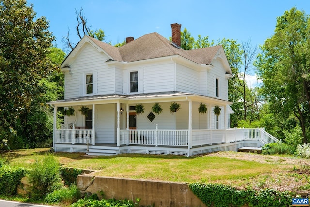 2010 White Bridge Rd, Waynesboro, VA 22980 - farmhouse inspired home with a chimney, a shingled roof, covered porch, a front lawn, and a standing seam roof