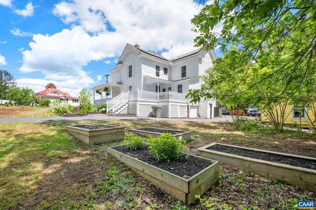 2010 White Bridge Rd, Waynesboro, VA 22980 - rear view of house featuring a vegetable garden, a chimney, and stairway