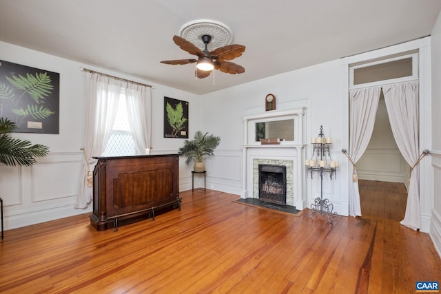2010 White Bridge Rd, Waynesboro, VA 22980 - living area featuring a decorative wall, ceiling fan, a fireplace with flush hearth, and wood-type flooring