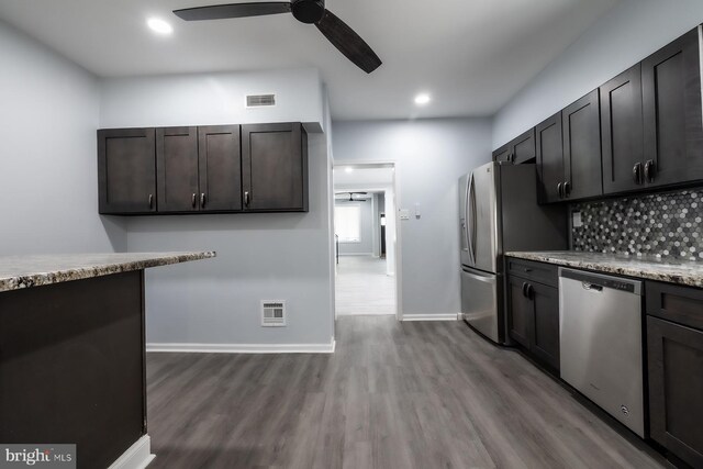 550 N 58th St, Philadelphia, PA 19131 - kitchen with appliances with stainless steel finishes, dark wood finished floors, a ceiling fan, tasteful backsplash, and baseboards