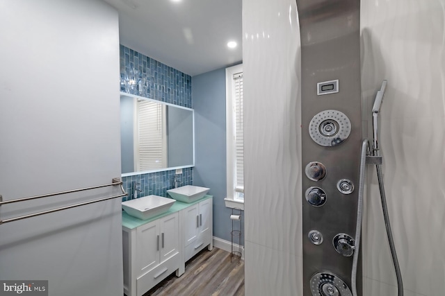 550 N 58th St, Philadelphia, PA 19131 - full bathroom with decorative backsplash, wood finished floors, double vanity, recessed lighting, and baseboards