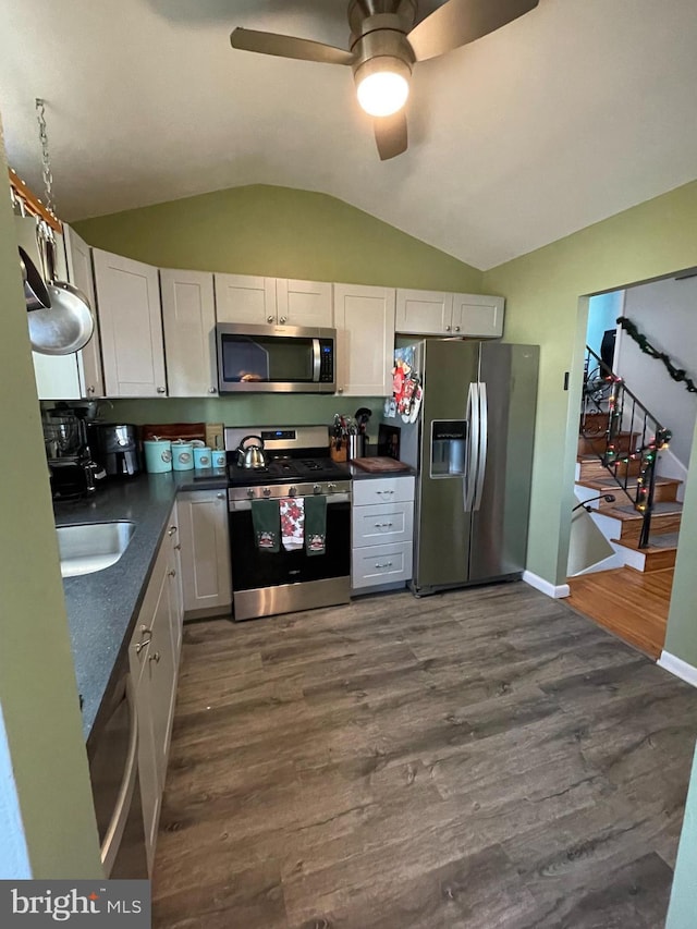 218 Hendrickson Ave, Beverly, NJ 08010 - kitchen featuring stainless steel appliances, dark countertops, lofted ceiling, a ceiling fan, and white cabinetry