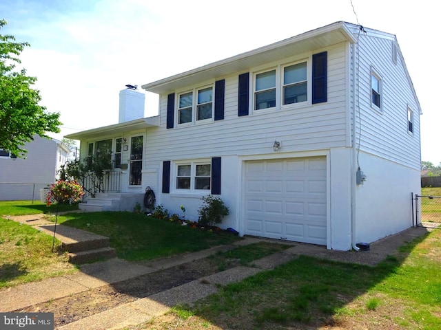 218 Hendrickson Ave, Beverly, NJ 08010 - tri-level home featuring an attached garage, a chimney, and stucco siding