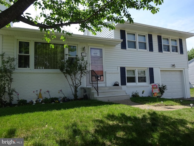 218 Hendrickson Ave, Beverly, NJ 08010 - tri-level home with brick siding, a garage, and a front yard