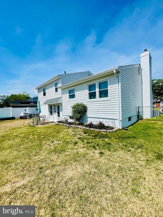 218 Hendrickson Ave, Beverly, NJ 08010 - back of house featuring a chimney, a patio, and central AC unit