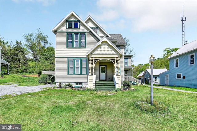 victorian home with covered porch and a front lawn