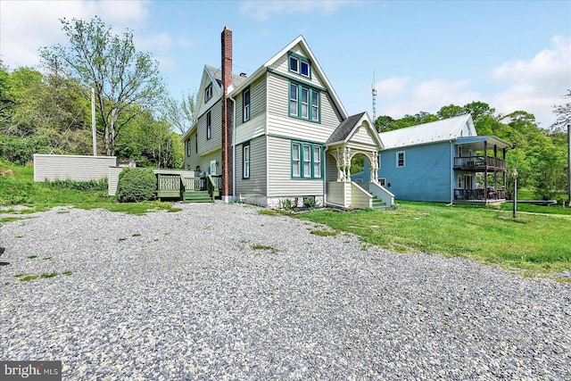 view of front of home with a deck and a chimney