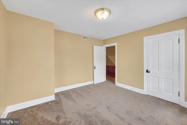 unfurnished bedroom with carpet flooring and baseboards