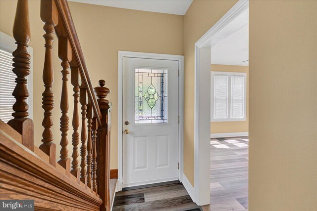 foyer entrance featuring dark wood-type flooring and baseboards