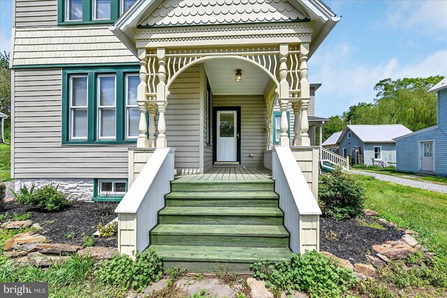 view of exterior entry with a porch