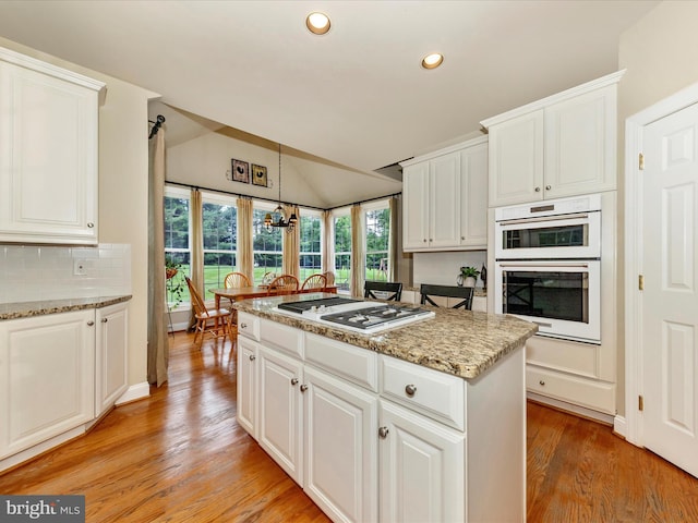 16013 Pheasant Ridge Ct, Woodbine, MD 21797 - kitchen featuring white appliances, recessed lighting, vaulted ceiling, light wood finished floors, and decorative backsplash