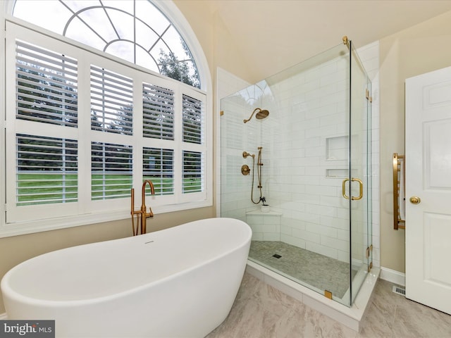 16013 Pheasant Ridge Ct, Woodbine, MD 21797 - bathroom featuring healthy amount of natural light, a stall shower, a freestanding tub, and marble look tiles