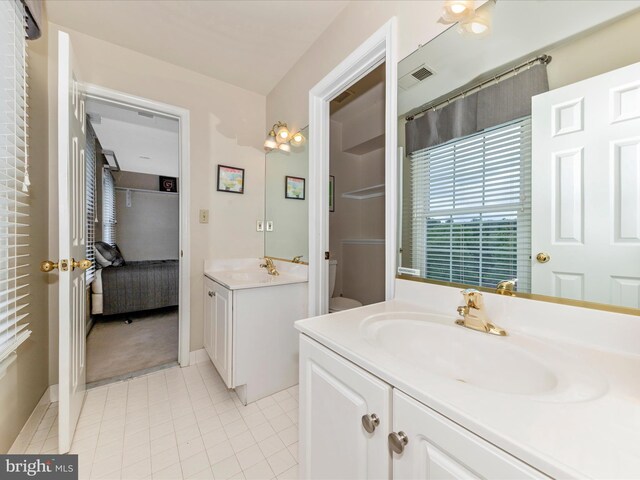 16013 Pheasant Ridge Ct, Woodbine, MD 21797 - ensuite bathroom with two vanities, tile patterned flooring, and baseboards