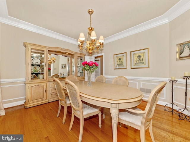 16013 Pheasant Ridge Ct, Woodbine, MD 21797 - dining space with a chandelier, ornamental molding, light wood-style floors, and a wainscoted wall