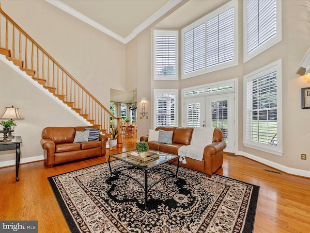16013 Pheasant Ridge Ct, Woodbine, MD 21797 - living area with stairway, wood finished floors, crown molding, a towering ceiling, and baseboards